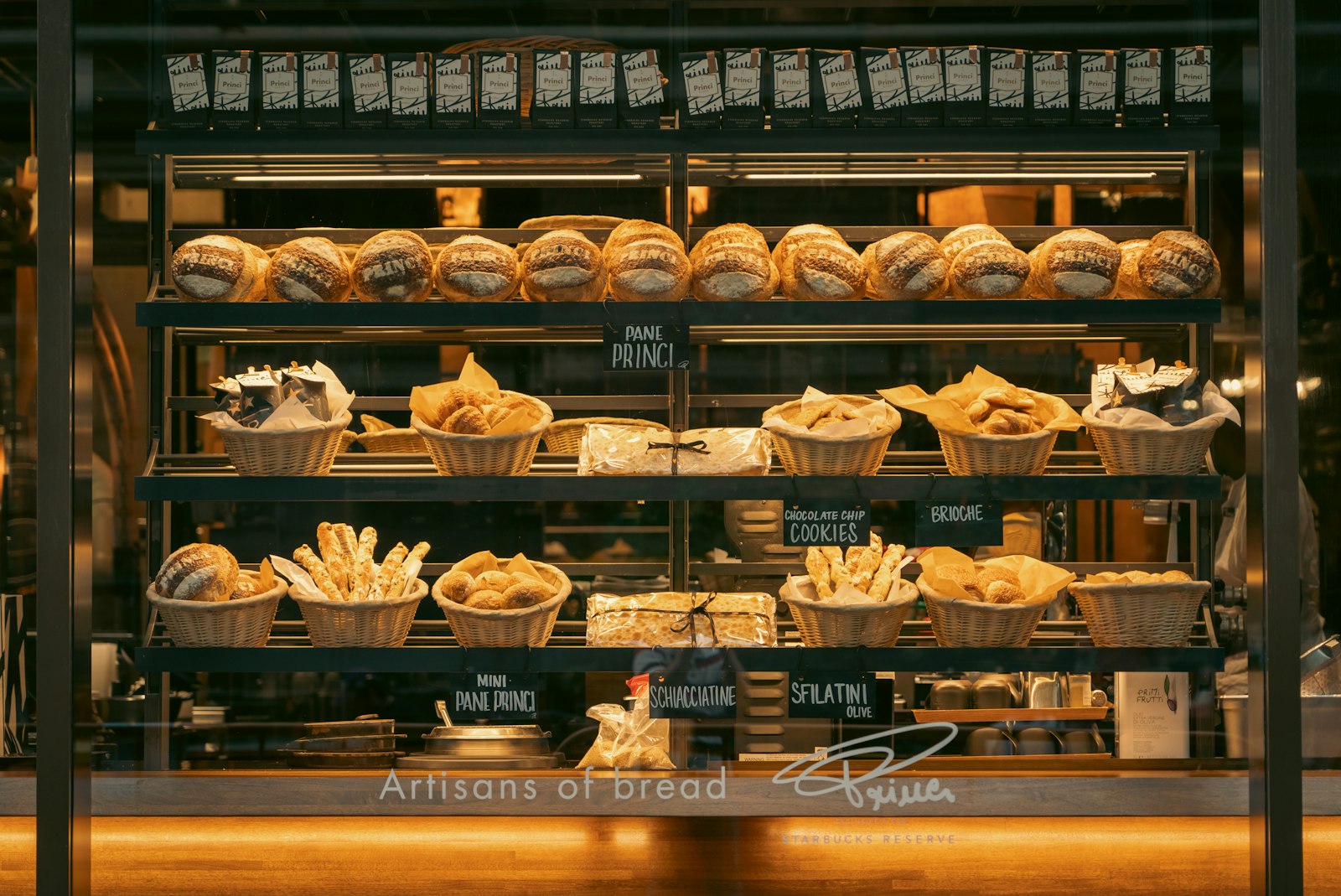 The bakery counter at opening, shelves stocked with the morning bake