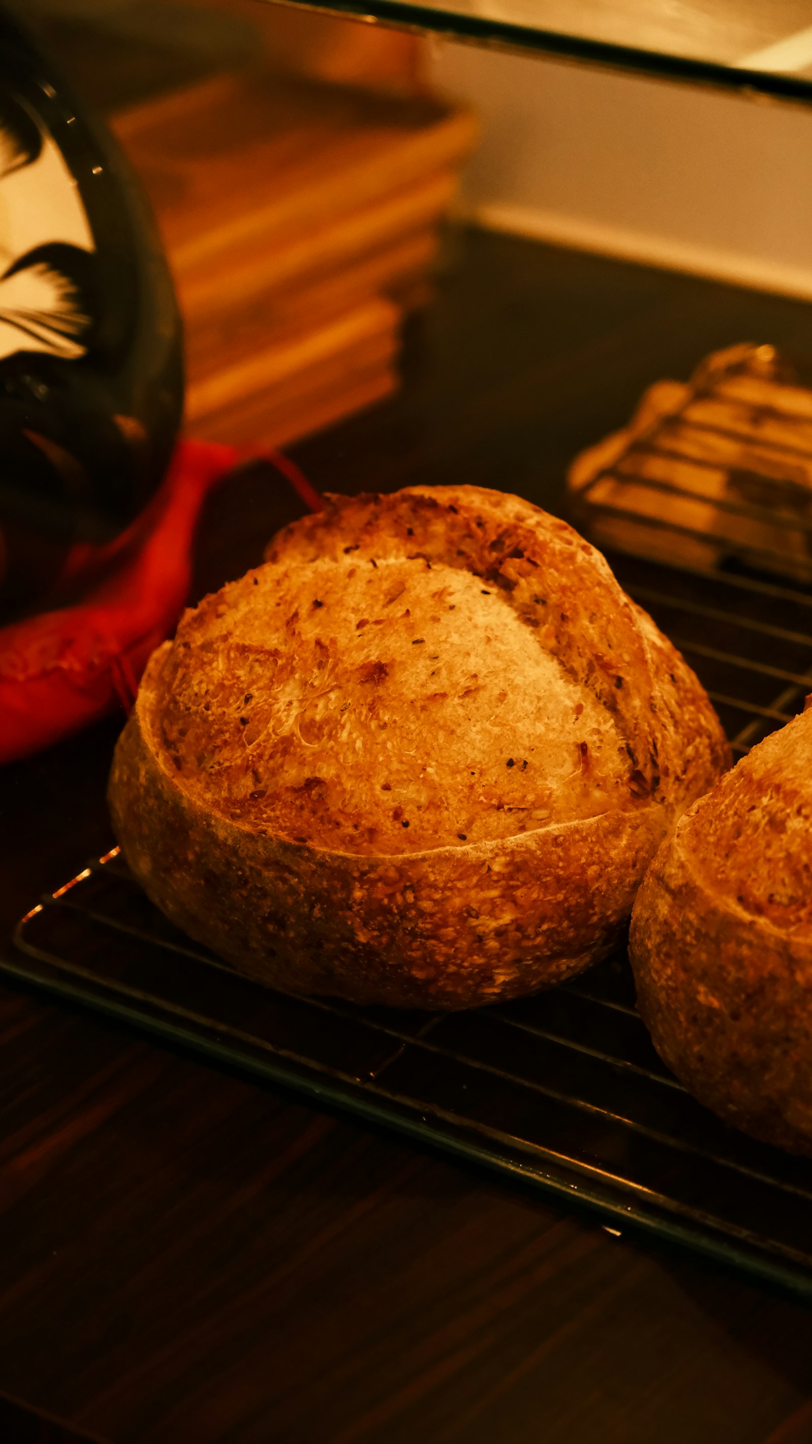 Rustic loaves on a wire rack, ready for the wholesale route