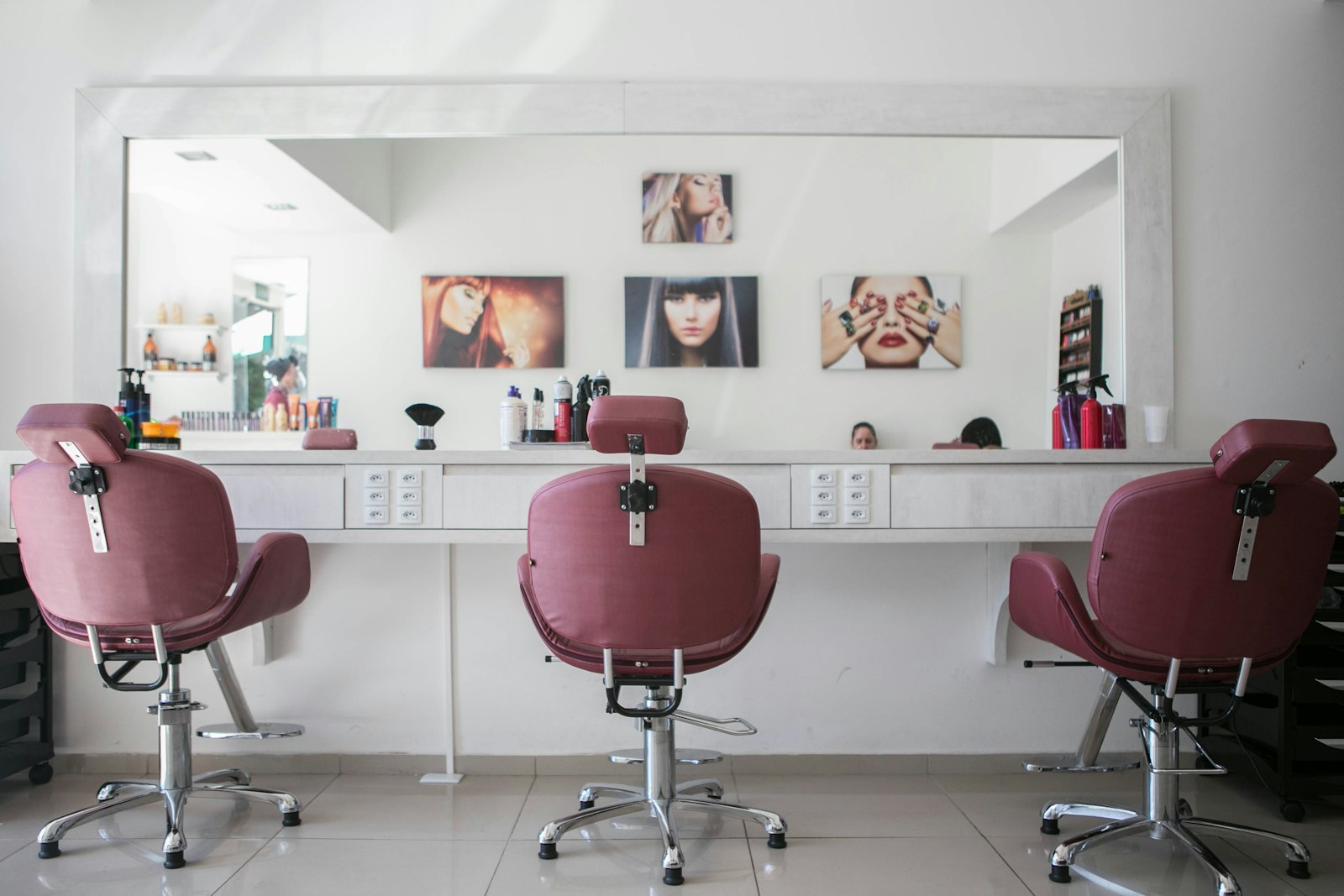 The academy's student salon with chairs, mirrors, and a row of styling stations between class sessions.