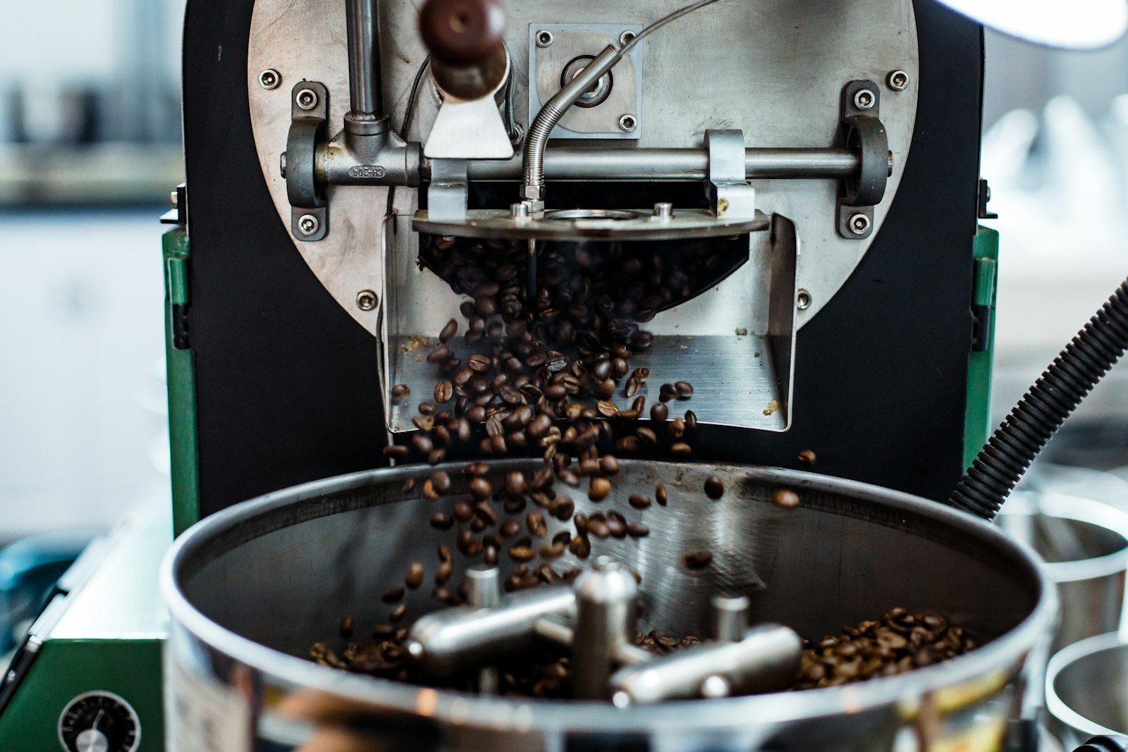 Whole coffee beans being ground, captured mid-motion