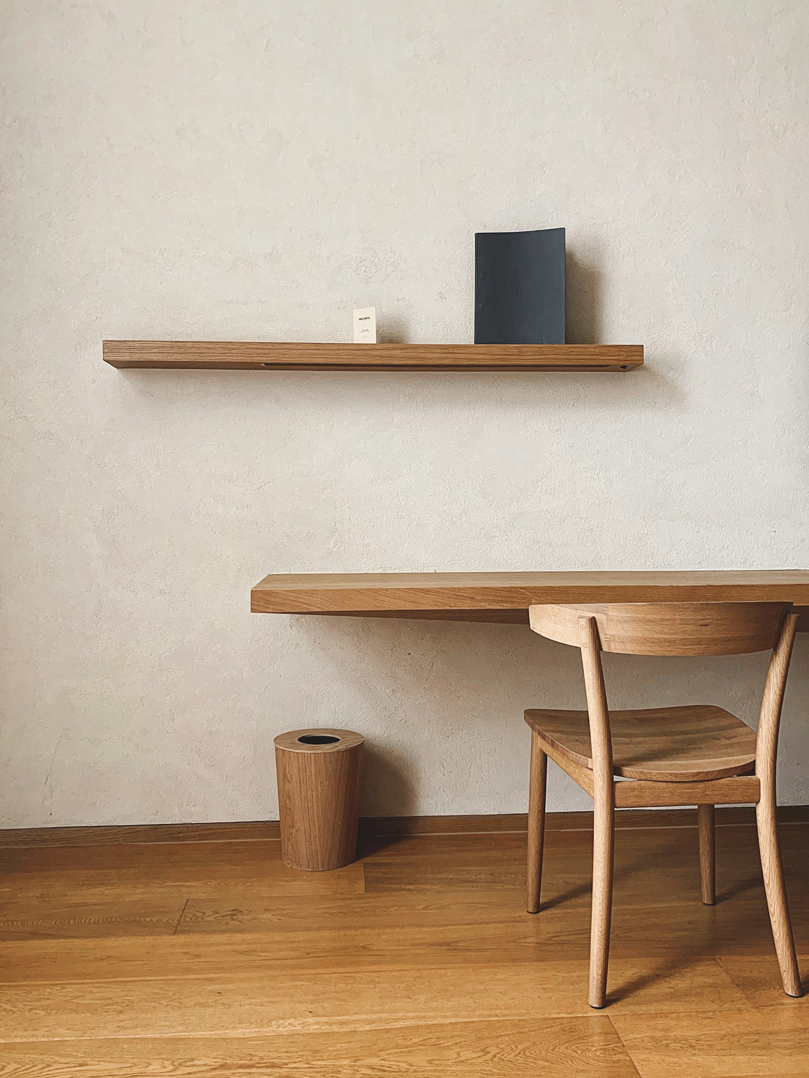 Brown wooden table with chairs in a restrained workspace.
