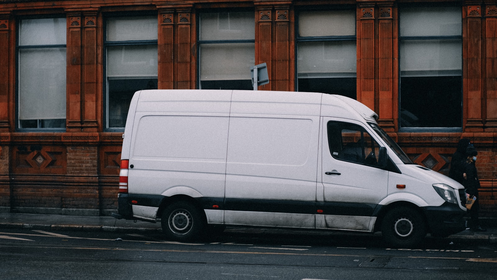 White HVAC service van parked street-side at golden hour