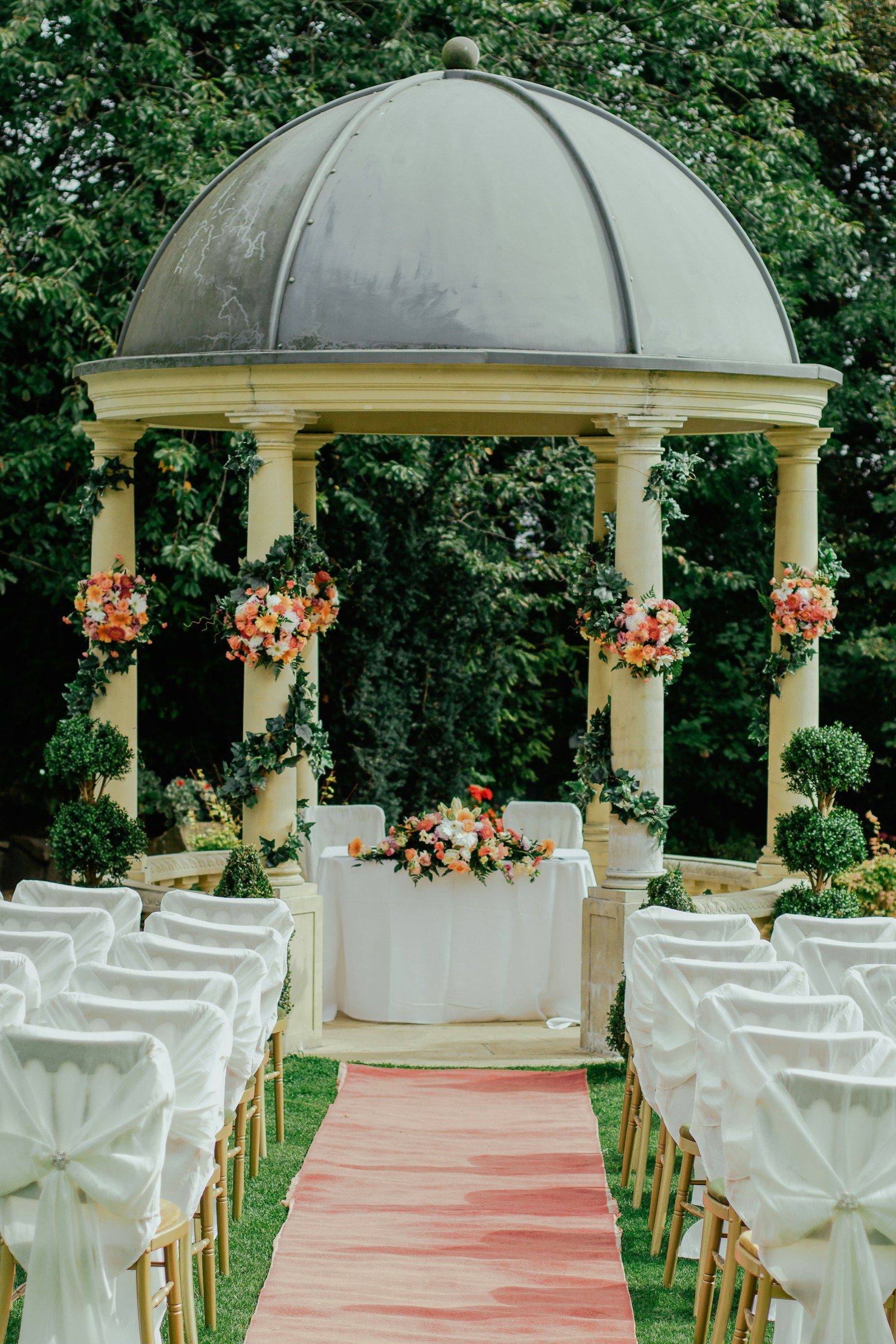 A gazebo and a clear stand of trees, an hour before guests arrive.