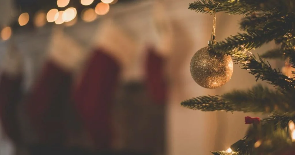 A decorated Chirstmas tree in focus.