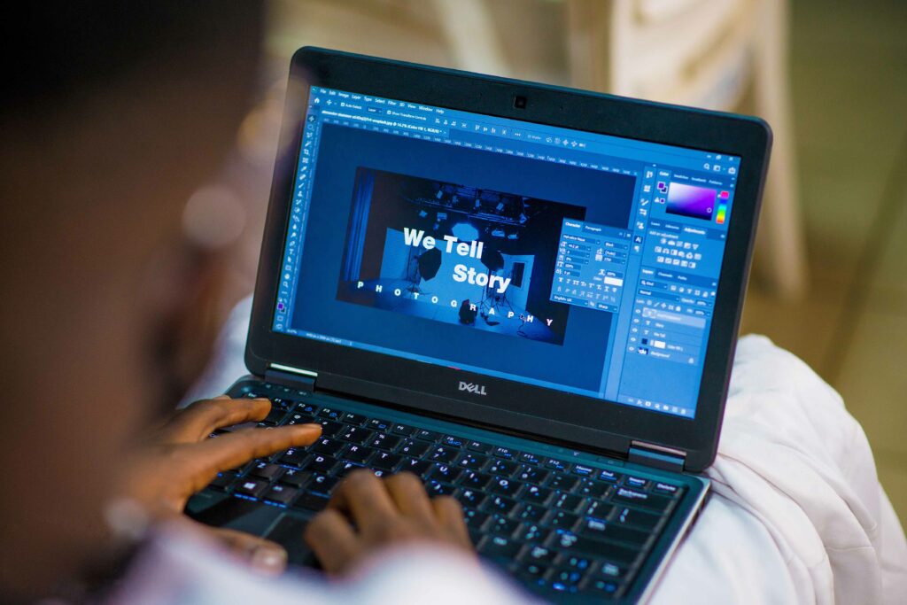 A person working on their laptop on Photoshop.