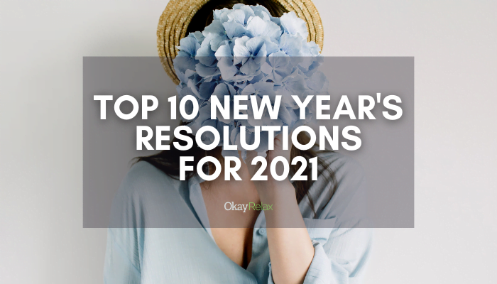 A woman holding light blue flowers on her face. The blog title is lightly layered over and reads, "Top 10 New Year's Resolutions for 2021".