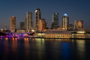 A city by the riverside in the night.