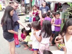Joseph doing his part distributing food to street children in urban poor communities.