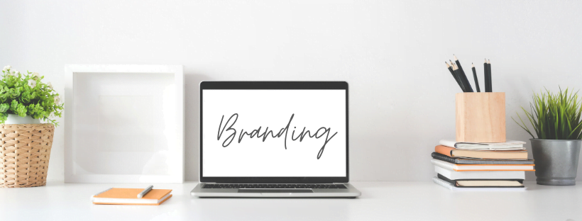 Clean, minimal, modern workspace. The laptop screen reads, "Branding," in cursive.