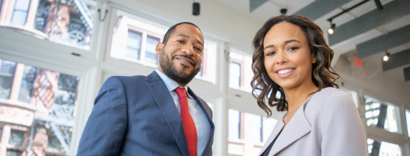 Two business owners smiling.