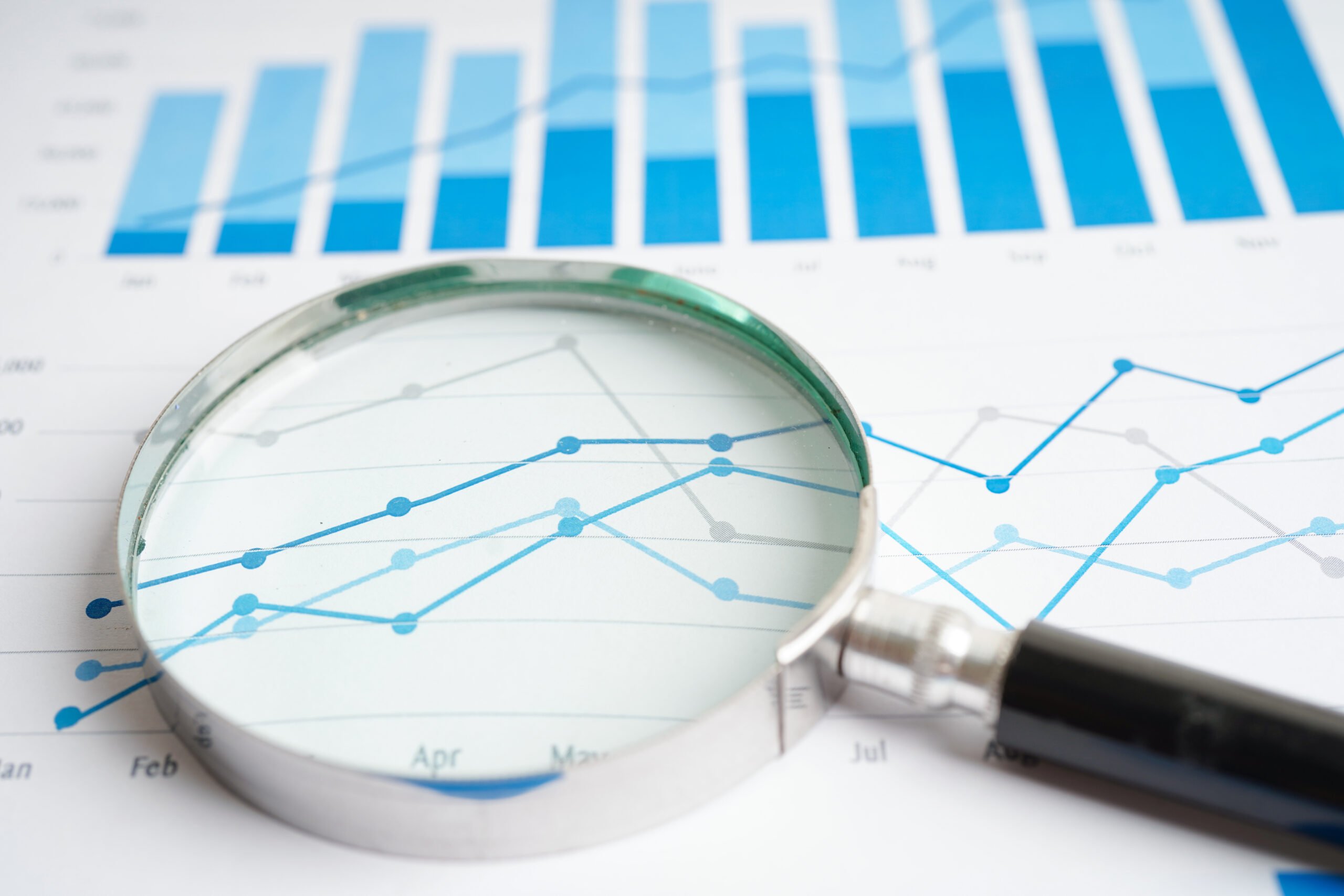 magnifying glass on trends charts