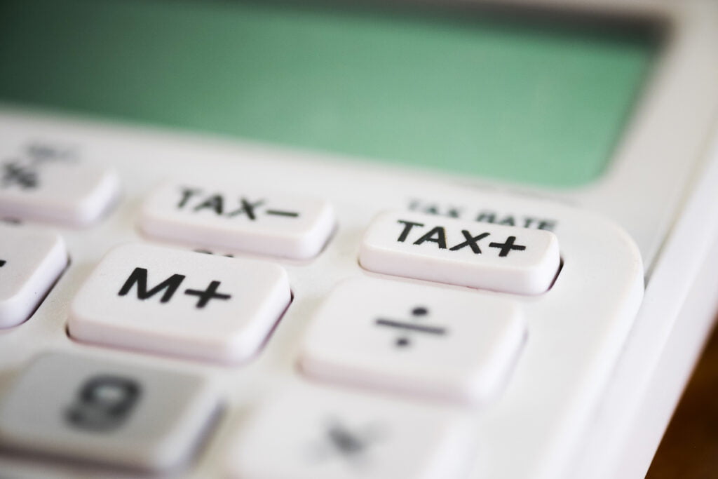 calculator showing tax plus and minus sign