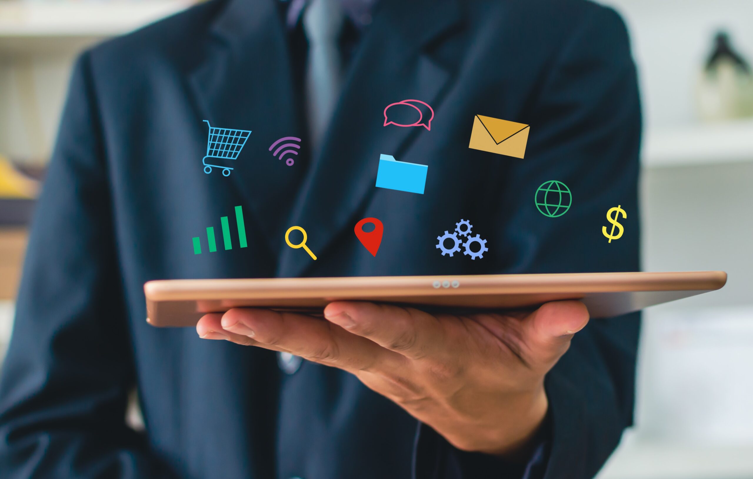 man holding a tablet with icons of virtual marketing